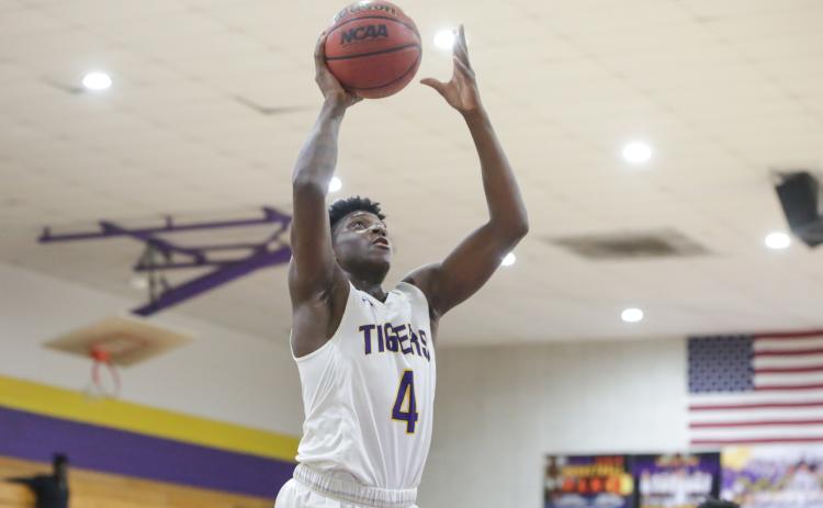 Columbia forward Marcus Peterson goes up for a shot against Santa Fe on Feb. 4.  Peterson scored 32 points in Thursday’s 96-73 win over Tate in the Region 1-6A quarterfinals. (BRENT KUYKENDALL/Lake City Reporter)