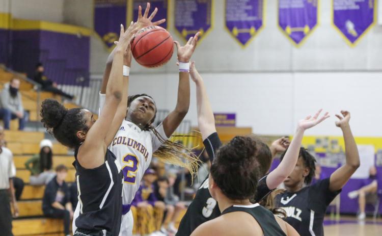 Columbia guard Na’Haviya Paxton is fouled by Buchholz forward Alicia Bryant during Friday’s District 2-6A championship game. (BRENT KUYKENDALL/Lake City Reporter)