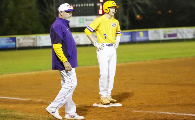 Columbia outfielder Kade Jackson stands on third base alongside coach Brian Thomas during Friday night’s game against Baker County. (BRENT KUYKENDALL/Lake City Reporter)
