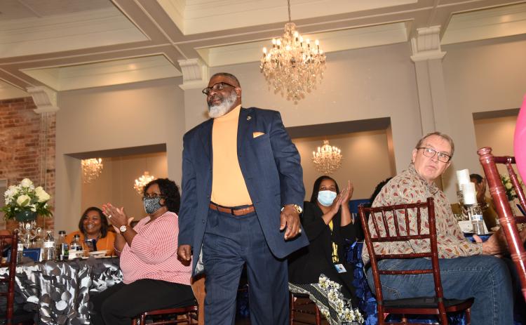 Carlos Brown is cheered as he prepares to accept his award as the Columbia County School District’s School-Related Employee of the Year at a luncheon at The Blanche last week. (COURTESY)