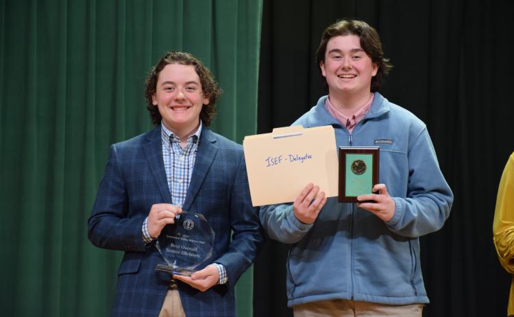 The Suwannee Valley Science Fair was held Thursday at Florida Gateway College with Fort White High School and Fort White Middle School taking home the top honors with the best overall winner in both the junior and senior divisions. Winning the Best Overall Senior Division Award were Fort White’s Trace Taylor (from left) and Trey Tyre for their project, ‘The Effect of a 1% Microflora Inoculant Soil Solution on Cucumber Nutrient Density, Plant Growth, and General Health.’ (COURTESY)