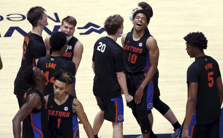 Florida players celebrate after a win against West Virginia on Jan. 30 in Morgantown, W.Va. (KATHLEE BATTEN/Associated Press)