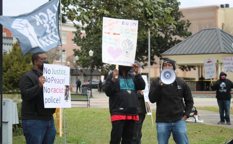 Sylvester Warren (right) uses a megaphone chanting 'No Justice, No peace; No racist police' during a Black Lives Matter protest where protesters we’re asking for police reform and better oversight. (TONY BRITT/Lake City Reporter)