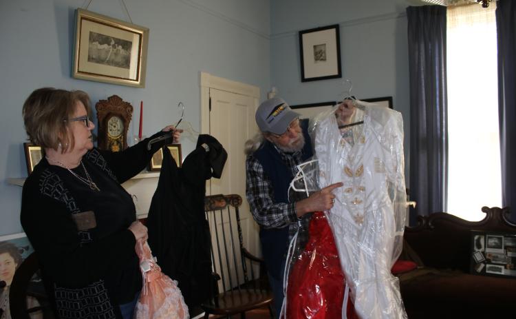 Kim Estergren, Lake City-Columbia County Historical Museum president-elect, and Harry Joiner, past president, work on moving dresses for the museum’s dress sale fundraiser today and Saturday. The sale will last from 9 a.m. to 1 p.m. both days at the museum, 157 SE Hernando Avenue. (TONY BRITT/Lake City Reporter)
