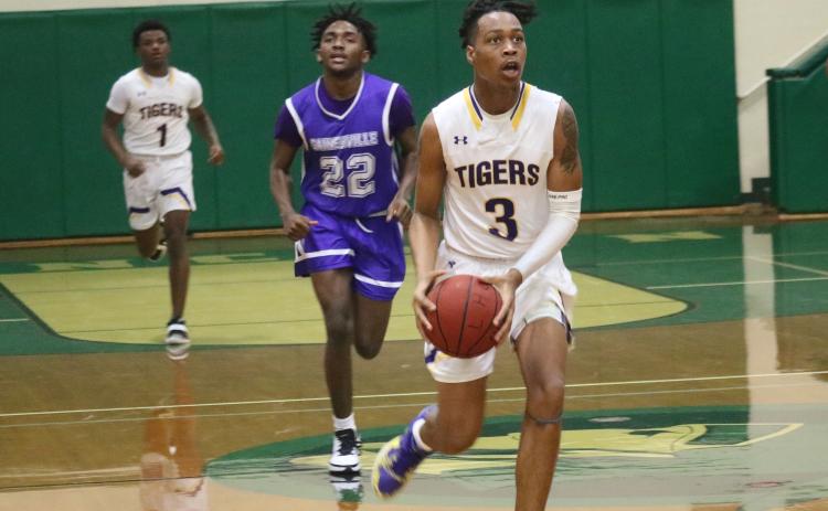 Columbia guard Charleston Ponds pushes the ball up the floor in transition against Gainesville during the District 2-6A semifinals Wednesday night at Lincoln High School. (JORDAN KROEGER/Lake City Reporter)