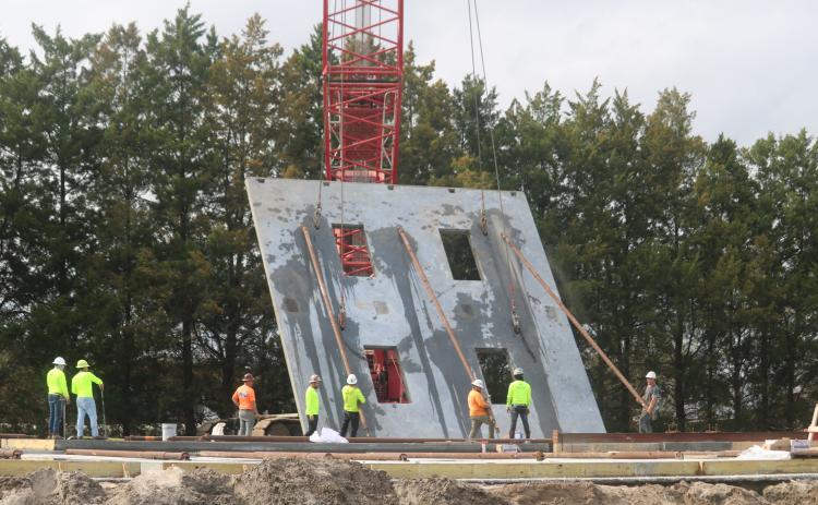 Construction crews lift a wall for the new two-story Belmont Academy building on Tuesday. The walls were being erected Tuesday and Wednesday with the facility expected to open this fall. (TONY BRITT/Lake City Reporter)