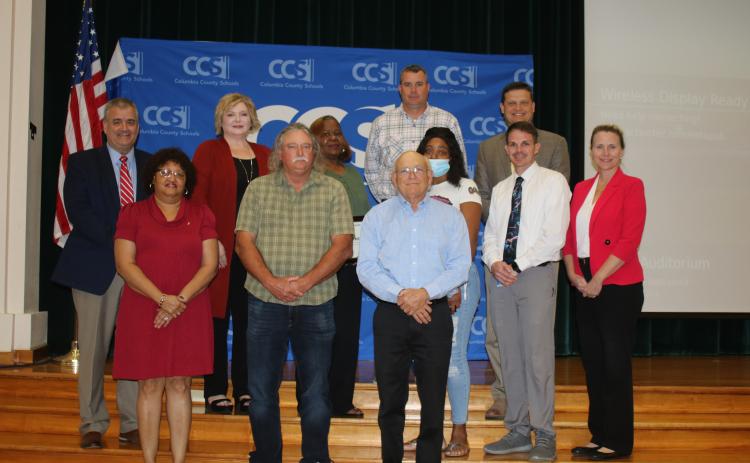 Columbia County school district staffers were honored after they saved maintenance department worker Jim Osburn last year after he fell off a ladder. The brief recognition ceremony took place Tuesday night during the school board meeting. Narrie Smith (front row, from left) Osburn and Keith Hudson. (Back row, from left) Lex Carswell, Stephanie Johns, Phyllisteen Reese, Casey Starling, Sandra Bing, Steve Nelson, Robert Cooper and Dana Brady-Giddens. (TONY BRITT/Lake City Reporter)