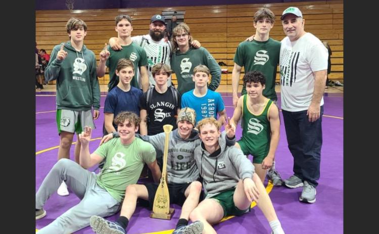 Suwannee's wrestling team poses in celebration after defeating Columbia on Wednesday. (COURTESY)