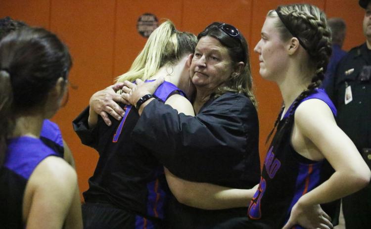 Branford forward Cera McElreath hugs head coach Carla Suggs following Tuesday’s loss to Trenton in the Region 3-1A finals. (MORGAN MCMULLEN/Lake City Reporter)