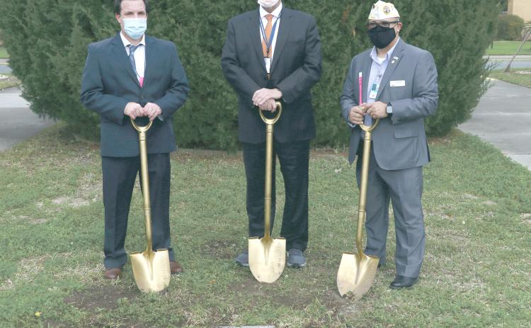 Lake City VA Medical Center Associate Director Chad Adams (from left), North Florida/South Georgia Veterans Health System Director Tom Wisnieski and Disabled American Veterans state commander Thomas Ayala took turns digging into the west lawn of the Lake City VA Medical Center yesterday. (MORGAN MCMULLEN/Lake City Reporter)