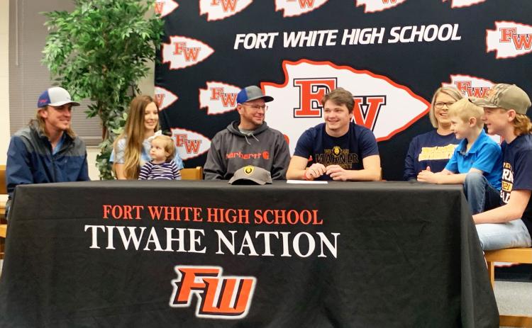 Fort White linebacker Colby Holton (middle) smiles during his signing ceremony Friday morning surrounded by his family. Holton signed with Warner University. (COURTESY)
