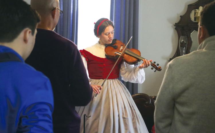 Emily-Jane Curtis, a dual-enrolled student at North Florida Community College, plays Civil War-era songs on her viola during Saturday’s ‘Blast Through the Past’ event at the Lake City-Columbia County Historical Museum. (MORGAN MCMULLEN/Lake City Reporter)