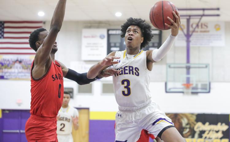 Columbia forward Charleston Ponds rises to the basket to shoot as Santa Fe center Ernest Ross defends during a game on Feb. 4. (BRENT KUYKENDALL/Lake City Reporter)