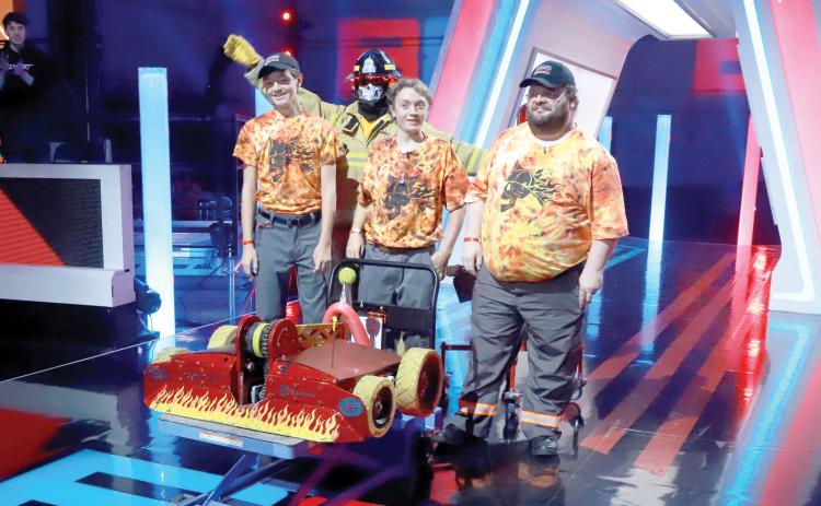 Lake City’s Brian Boatright (right) competed with Team Extinguisher on BattleBots in the 2020 season. John Flaacke IV (second from right) is the team’s captain and his father John III and brother Ben were also on the team. (COURTESY)