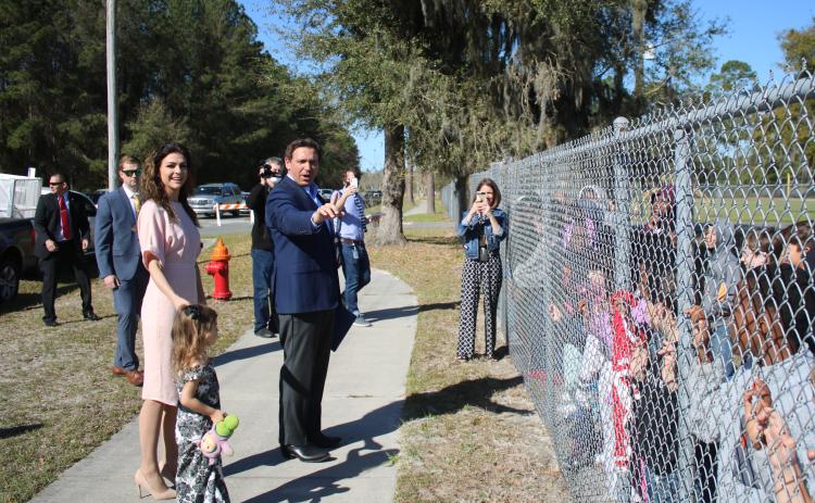 Madison DeSantis (from left), Casey Desantis and Gov. Ron DeSantis talk to Summers Elementary School students Thursday morning after the governor held a press conference at the Southside Sports Complex, across the street from Summers Elementary School, detailing recent covid vaccine distribution successes. (TONY BRITT/Lake City Reporter)