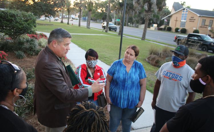 Sheriff Mark Hunter (left) discusses internet cafes with a group of supporters Thursday evening. (TONY BRITT/Lake City Reporter)