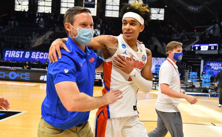 Florida head coach Mike White embraces Tre Mann after they defeated Virginia Tech in the first round of the NCAA Tournament at Hinkle Fieldhouse on March 19 in Indianapolis, Ind. (BRETT WILHELM/Pool Photo via AP)