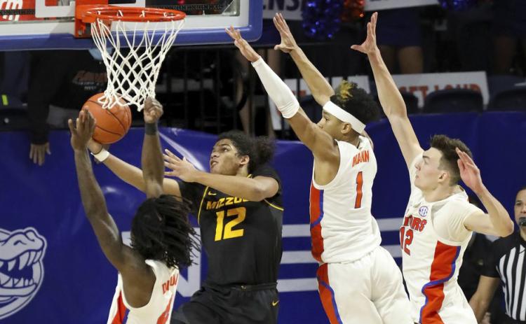 Missouri guard Dru Smith (12) goes up and under the basket to score the game-winning basket against Florida on Wednesday in Gainesville. (BRAD MCCLENNY McClenny/The Gainesville Sun via AP)