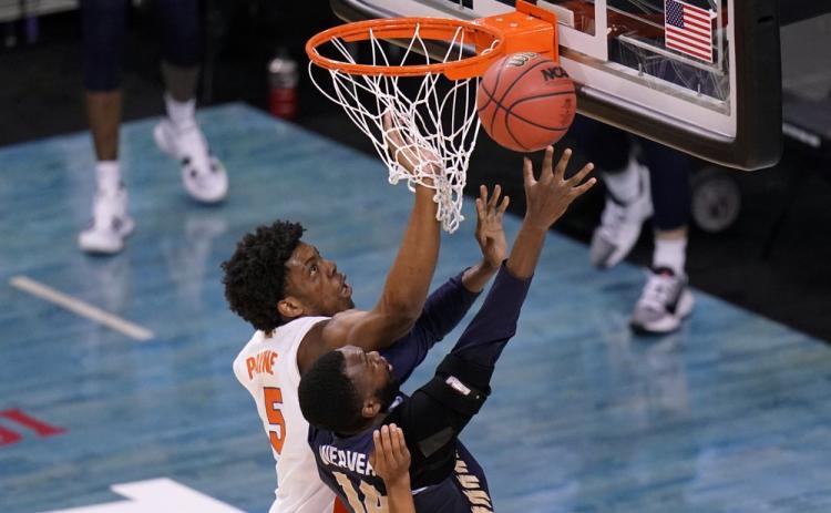 Oral Roberts forward DeShang Weaver (14) shoots ahead of Florida forward Omar Payne (5) during the second round of the NCAA Tournament at Indiana Farmers Coliseum on March 21 in Indianapolis. (AJ MAST/Associated Press)