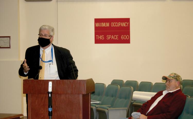 Daniel Sweat (left) speaks to the Lake City Council in a December meeting as Paul Dyal looks on. (FILE)