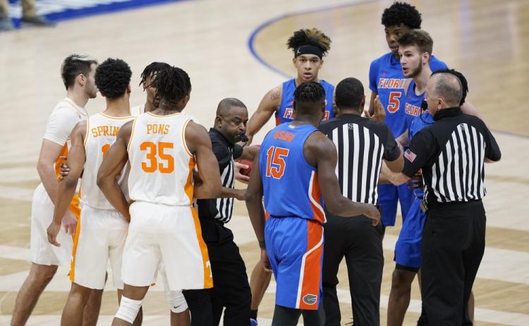 Tennessee and Florida players are separated after a foul by Florida's Omar Payne (5) in the second half of  the Southeastern Conference Tournament quarterfinals on Friday in Nashville, Tenn. Payne was ejected from the game after dealing a pair of elbows to John Fulkerson. (MARK HUMPHREY/Associated Press)