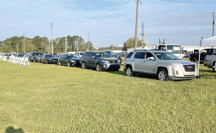 Vehicles line up Thursday morning at the Florida Gateway Fairgrounds parking lot to receive the covid-19 vaccine. (COURTESY)