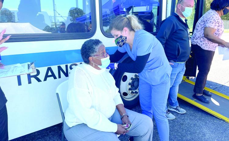 Blondell Johnson receives a vaccination shot Thursday after receiving a ride from the Richardson Community Center to the vaccination site. (COURTESY)