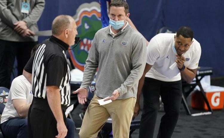 Florida head coach Mike White talks with an official in the first half of a game against Tennessee in the Southeastern Conference Tournament March 12 in Nashville, Tenn. (MARK HUMPHREY/Associated Press)