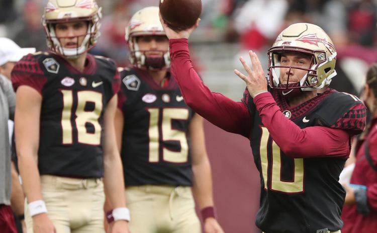 FSU quarterbacks Tate Rodemaker (18) and Gino English (15) watch quarterback McKenzie Milton (10) throw during the FSU Garnet & Gold Spring Game at Doak Campbell Stadium on April 10 in Tallahassee. (STEPHEN M. DOWELL/Orlando Sentinel)