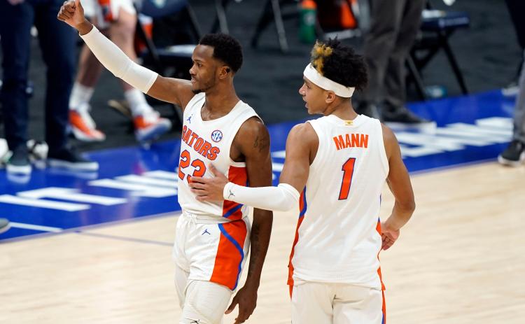 Florida's Scottie Lewis (23) and Tre Mann (1) leave the court after the Gators' win against Vanderbilt during the SEC Tournament last month. (MARK HUMPHREY/Orlando Sentinel/TNS)