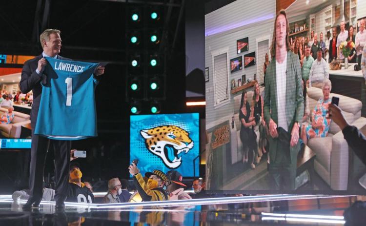 NFL Commissioner Roger Goodell congratulates quarterback Trevor Lawrence on being selected as the first pick in the 2021 NFL Draft by the Jacksonville Jaguars on Thursday in Cleveland. (JOHN KUNTZ/cleveland.com)