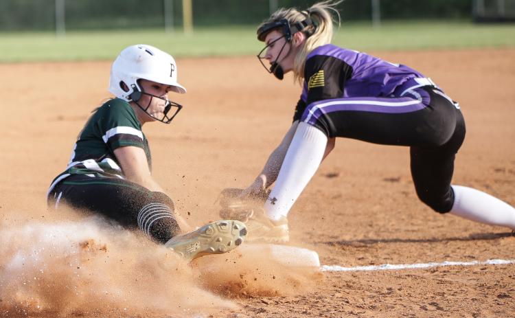 Suwannee pitcher Karis Smith beats the tag from Columbia third baseman Anissa Penniman to slide safely into third base during Tuesday night’s game. (BRENT KUYKENDALL/Lake City Reporter)
