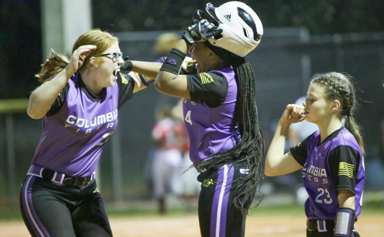 Columbia’s Hailey Bowmer (left) and Karis Jernigan celebrate after the Tigers’ 10-9 win over Bradford on Friday night. (BRENT KUYKENDALL/Lake City Reporter)