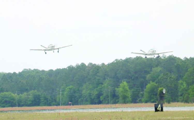 Two Beechcraft Bonanza airplanes take off from the Lake City Gateway Airport runway 10/28 on Friday afternoon. (TONY BRITT/Lake City Reporter)