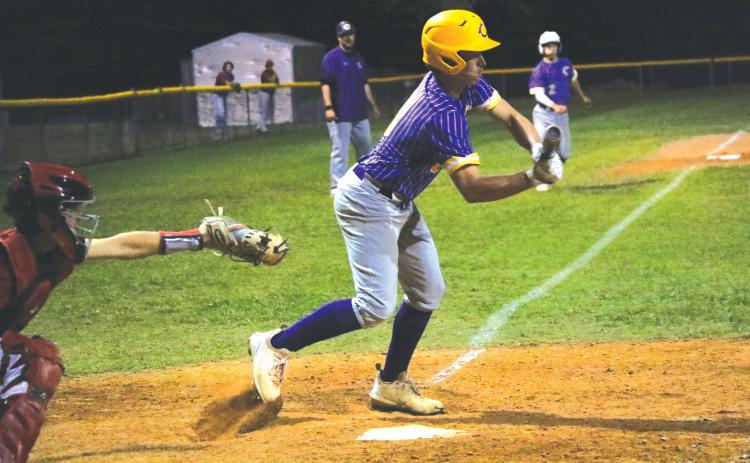 Columbia second baseman Truitt Todd lays down a bunt to score Cole Williams for the  game-winning win against Baker County on Tuesday night. (MORGAN MCMULLEN/Lake City Reporter)