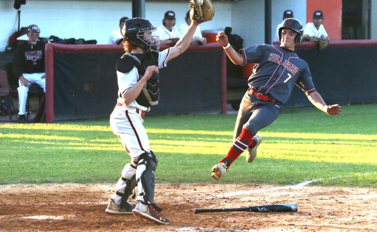 Fort White catcher Brad Sullivan (left) grabs a relay throw from right field but can’t apply the tag to a sliding Brantley Hengerer during the top of the third inning of the Indians’ 3-1 loss Monday night against Hilliard. (MORGAN MCMULLEN/Lake City Reporter)