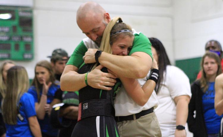 Suwannee weightlifter Matti Marsee hugs her father and assistant coach Dan Marsee after winning the Class 1A state title in the 110-pound weight class on Feb. 12. (PAUL BUCHANAN/Special to the Reporter)