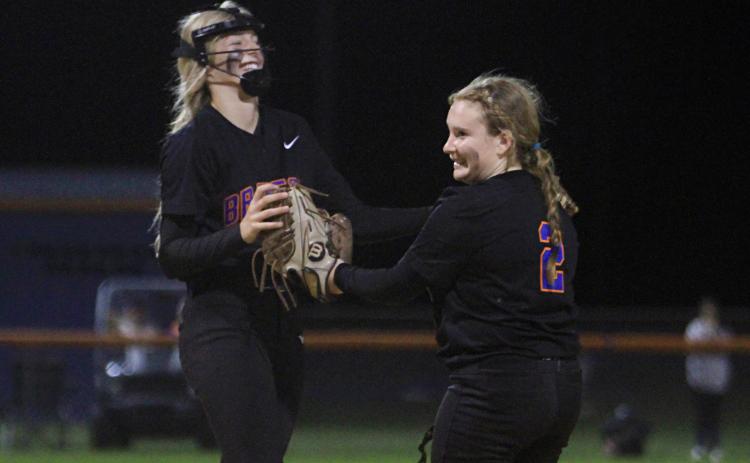 Branford third baseman Madison Sikes celebrates with pitcher Laila Arnold after an out against Fort White on Thursday night. (PAUL BUCHANAN/Special to the Reporter)