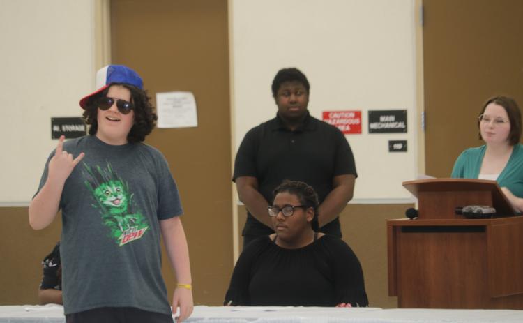 Nickolas Steward, foreground, portrays a skateboarder during a theatrical presentation Wednesday at the National Guard Armory during local National Youth Leadership Week festivities. (TONY BRITT/Lake City Reporter)