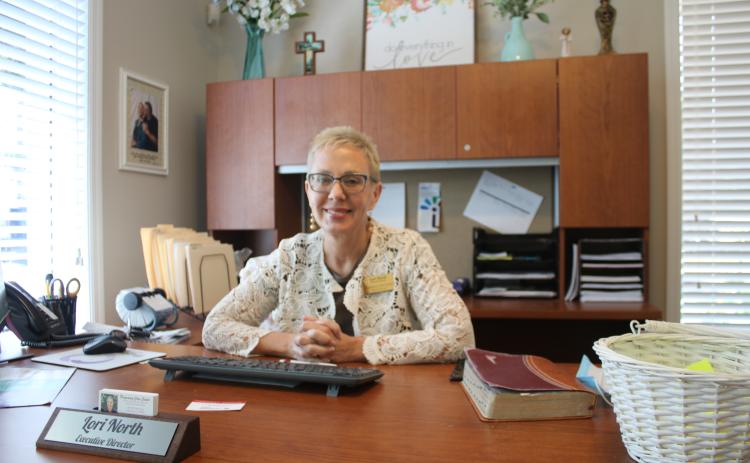 Lori North at her desk. (TONY BRITT/Lake City Reporter)