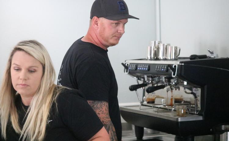 Brooke Bass (left) mixes up a drink at Suwannee Brew Coffee Co. alongside her husband Aaron. They just opened up their shop a couple of weeks ago to great reception. (JAMIE WACHTER/Lake City Reporter)
