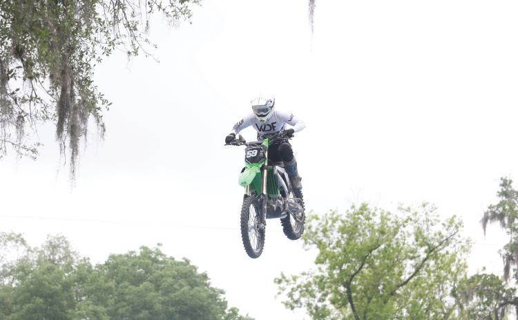 Team FMX rider Trevor Cartmill comes down on the landing ramp after jumping over Ellie Ray’s Bar at the Ellie Ray’s RV Resort & Lounge on Saturday afternoon. (MORGAN MCMULLEN/Lake City Reporter)