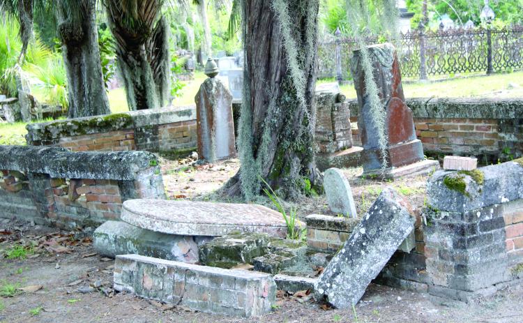 A family gravesite in Oaklawn Cemetery with an overturned tombstone, dilapidated brick wall and high grass is a common site at the local cemetery. (TONY BRITT/Lake City Reporter)