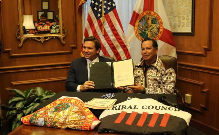 Gov. Ron DeSantis and Marcellus Osceola Jr., chairman of the Seminole Tribe of Florida, pose for a photo April 23 after signing a gambling compact. (MCT)