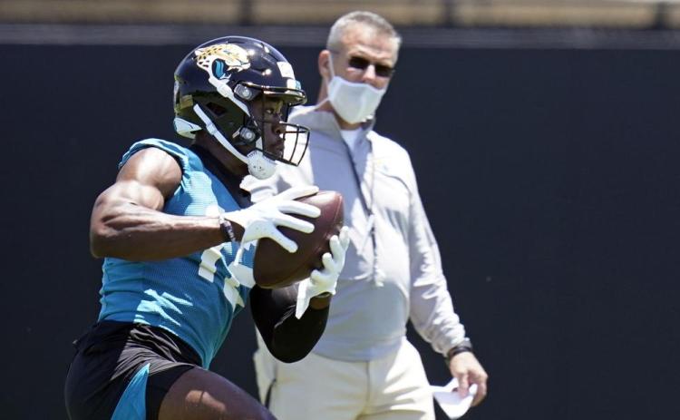 Jacksonville Jaguars wide receiver Jalen Camp, left, catches a pass as head coach Urban Meyer looks on during Saturday’s practice in Jacksonville. (JOHN RAOUX/Associated Press)