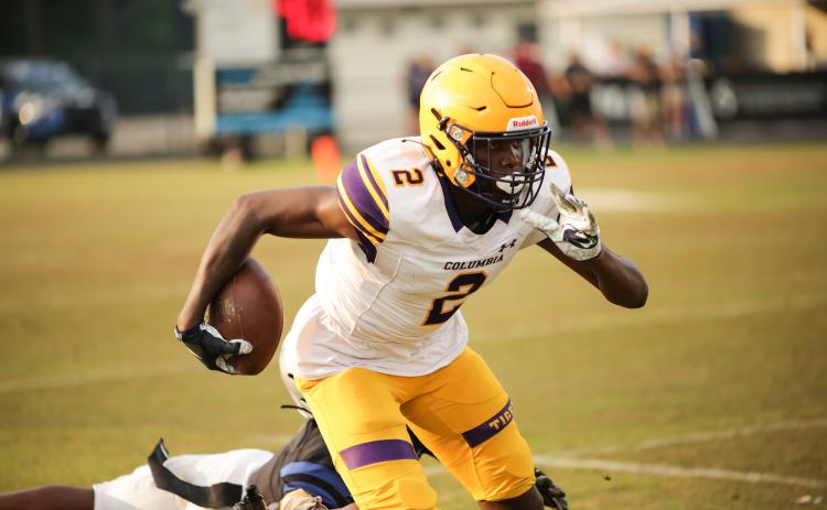 Columbia receiver Marcus Peterson races past a Bartram Trail defender after a catch Friday night in the Tigers’ spring game. (BRENT KUYKENDALL/Lake City Reporter)
