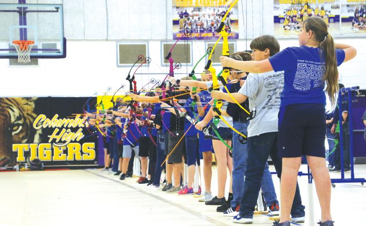 Students from Eastside, Westside and Pinemount Elementary schools line up their shots Friday afternoon in the NASP national tournament. (MORGAN MCMULLEN/Lake City Reporter)