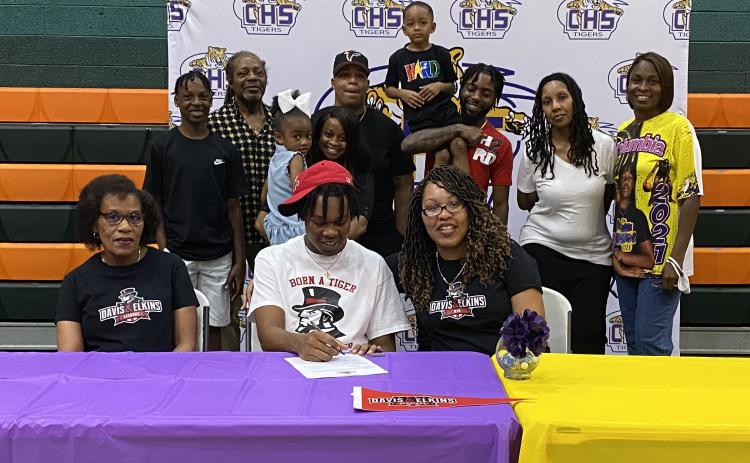 Columbia forward Charleston Ponds signs his letter of intent to play at Davis & Elkins College earlier this month. (COURTESY)