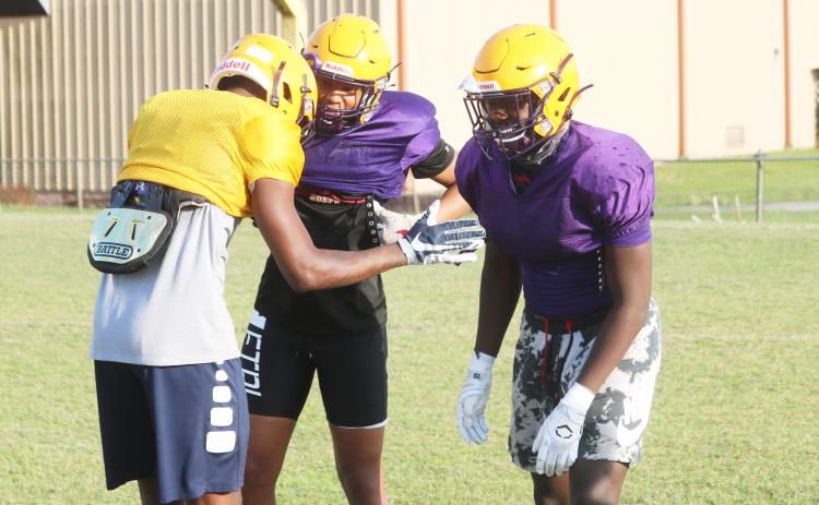 Columbia cornerback Amare Ferrell (middle) and linebacker Jaden Robinson (right) joke around with receiver Marcus Peterson after a play during practice on April 29. (JORDAN KROEGER/Lake City Reporter)
