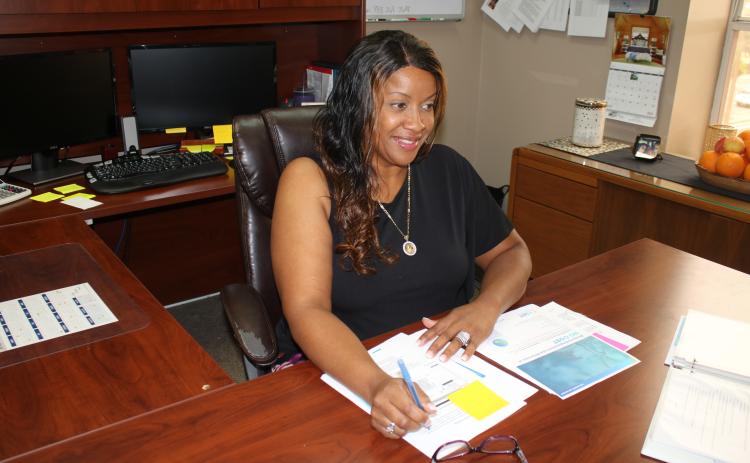 Ami Mitchell, Lake City Human Resources Department Director, works at her desk Wednesday afternoon. Mitchell began working at the city’s new human resources department director on April 5. (TONY BRITT/Lake City Reporter)